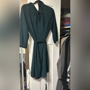 Le chateau unique knotted neckline and belted emerald dress